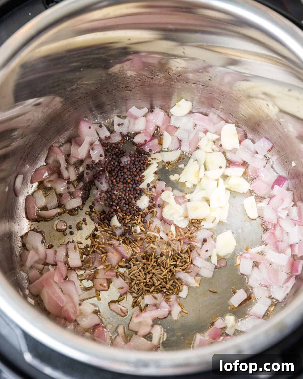 Perfect Instant Pot Mung Beans: Tender, Flavorful Every Time 18 Photo showing garlic and spices added to the Instant Pot.