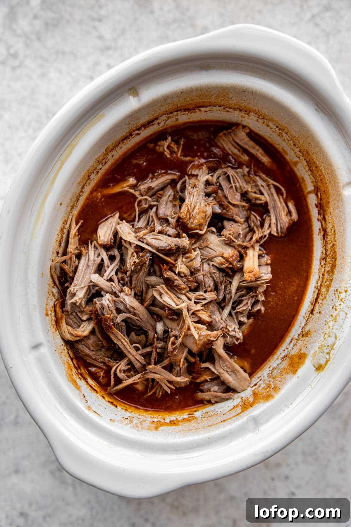 pulled pork added to a slow cooker in the sauce.