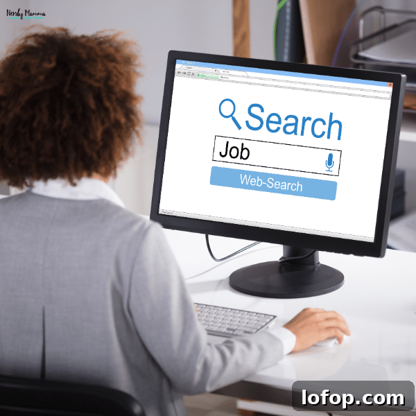 Woman sitting at a desk, searching for job opportunities on a computer, representing the process of finding work-from-home jobs for moms.