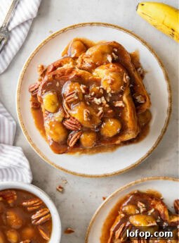 tabletop with plate of bananas foster french toast and chopped pecans garnish.