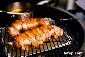 bacon wrapped pork tenderloin in smoker with glaze horizontal
