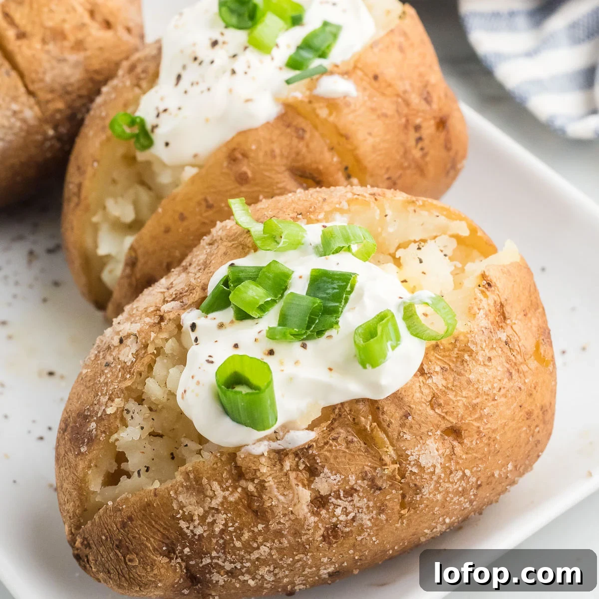 Smoked Baked Potatoes Recipe: Crispy Skins and Tender Centers 10 Baked potatoes with sour cream and green onions.