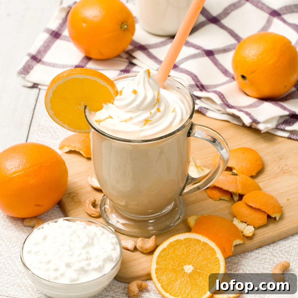 Fluffy Almond Flour Pancakes — Gluten-Free Recipe 5 An orange creamsicle smoothie in a Glass with sliced oranges.