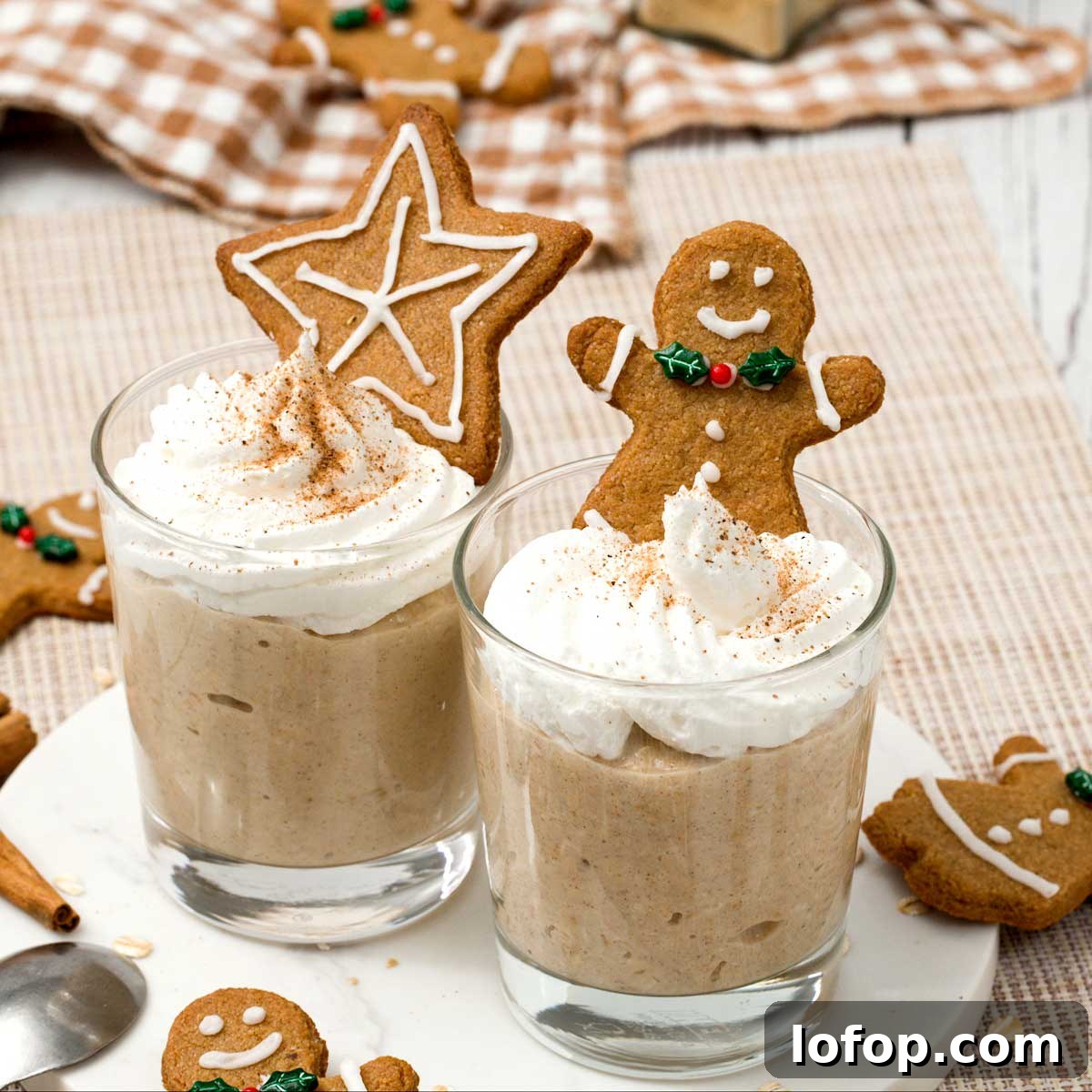 Fluffy Almond Flour Pancakes — Gluten-Free Recipe 7 Two glasses of gingerbread overnight oats with whipped cream on top and gingerbread cookies.