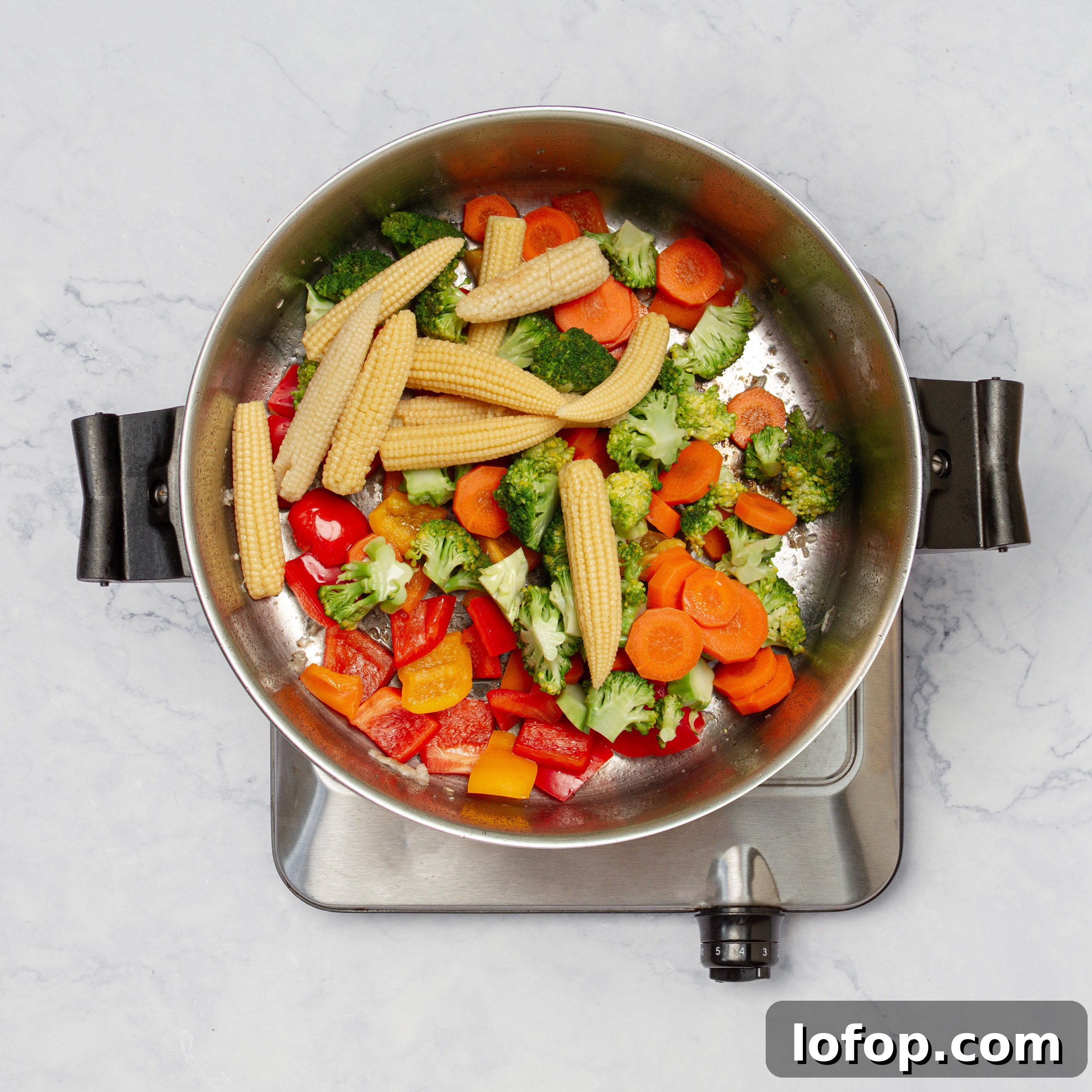 Quick Chicken Stir-Fry with Veggies and Garlic Sauce 7 Fresh and colorful veggies cooking in the hot pan.