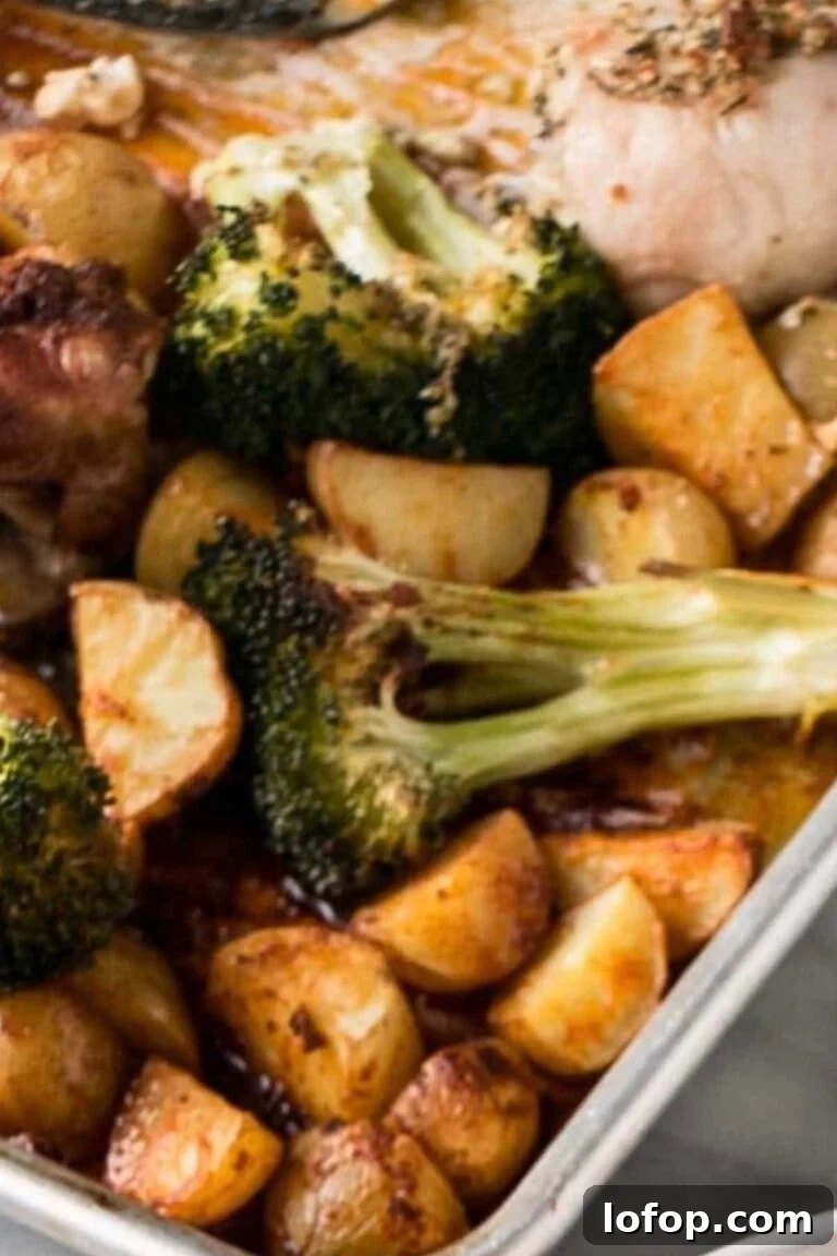 Roasted chicken thighs with potatoes and broccoli, featuring golden-brown crispy skins.