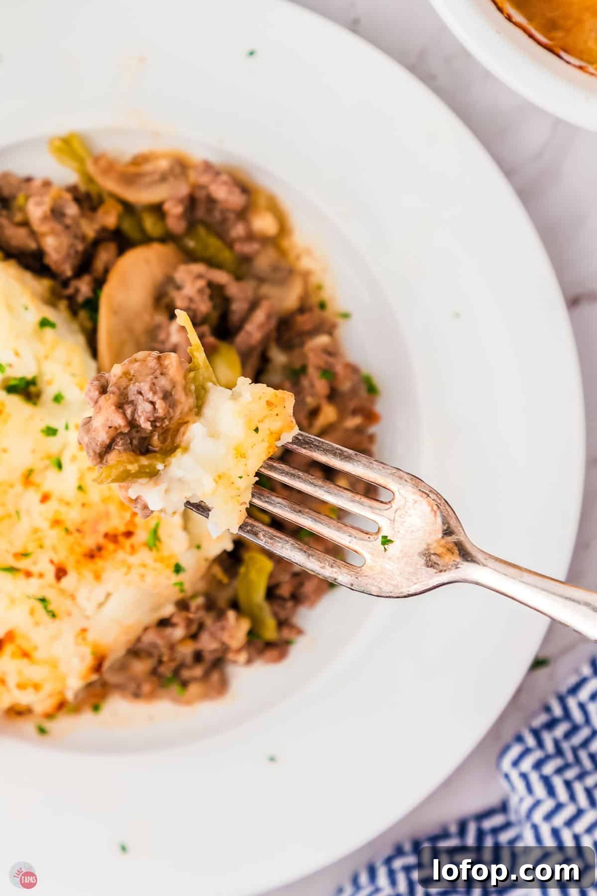 Hearty Salisbury Steak Casserole with Savory Brown Gravy 12 overhead picture with fork and a bite of casserole