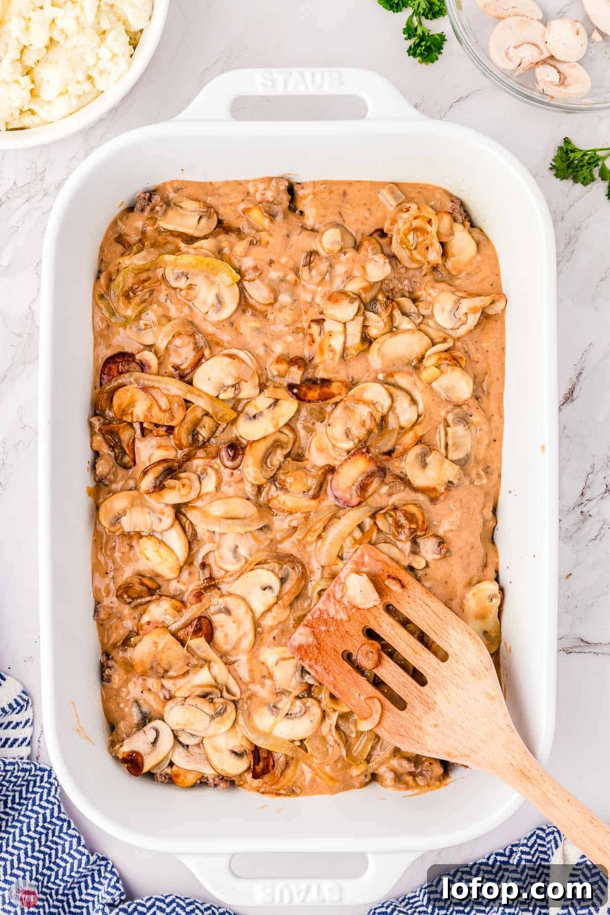 Hearty Salisbury Steak Casserole with Savory Brown Gravy 7 casserole dish with gravy and mushrooms on top