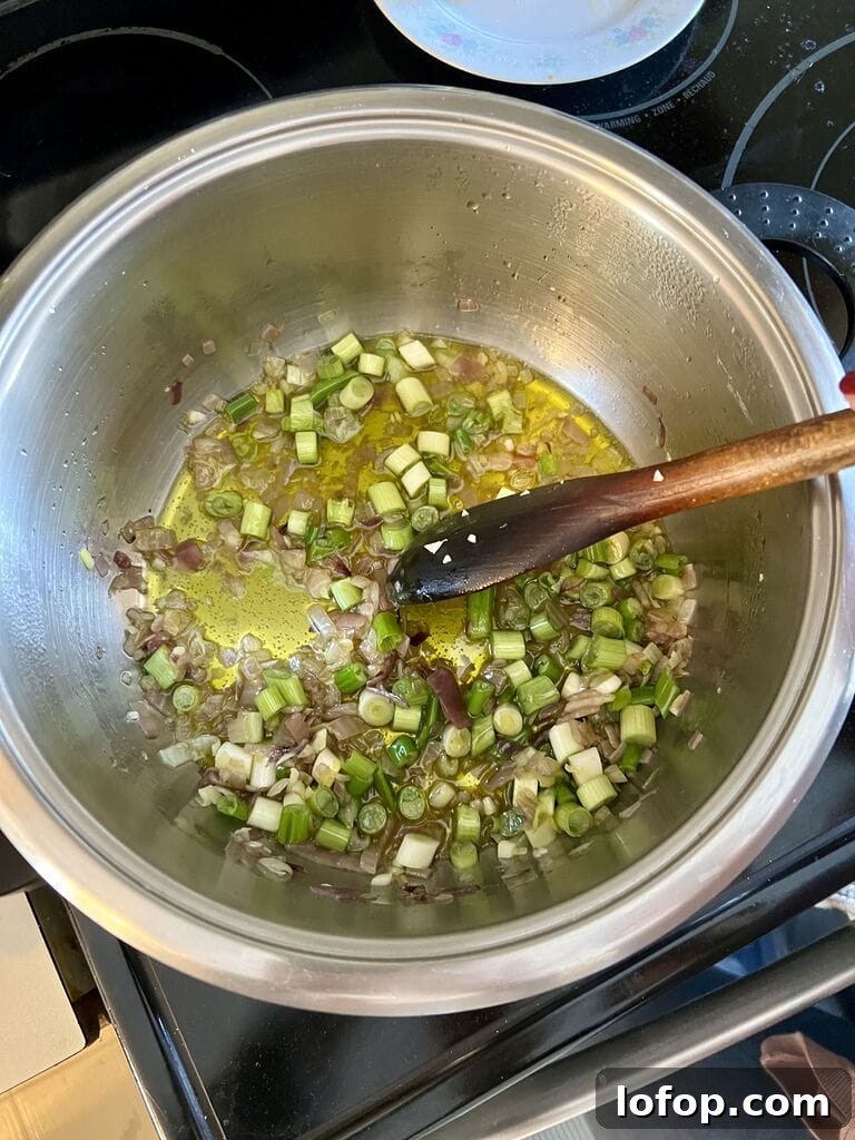 Sautéing the red and green onions.