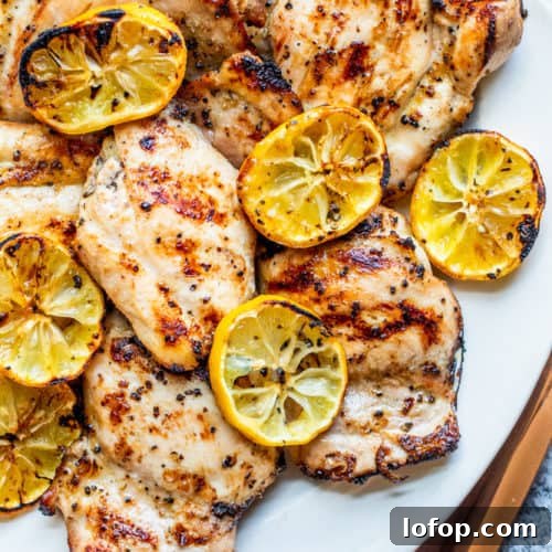 Overhead shot of chicken thighs on a white serving dish