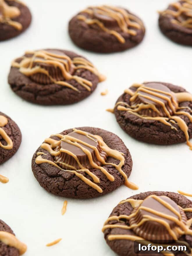 Irresistible Chocolate Peanut Butter Cup Cookie Recipe 3 chocolate peanut butter cup cookies with a drizzle of peanut butter on top