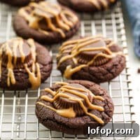 Irresistible Chocolate Peanut Butter Cup Cookie Recipe 9 chocolate peanut butter cup cookies on a wire rack