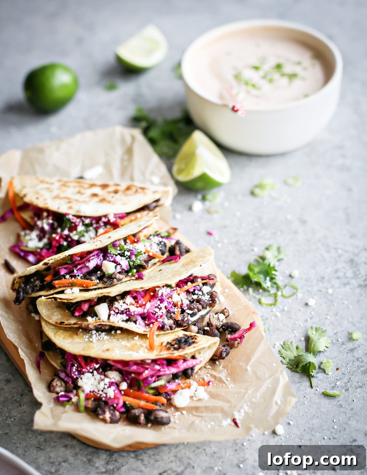Crispy Black Bean Tacos with Cilantro-Lime Slaw 8 photo of black bean tacos on a cutting board