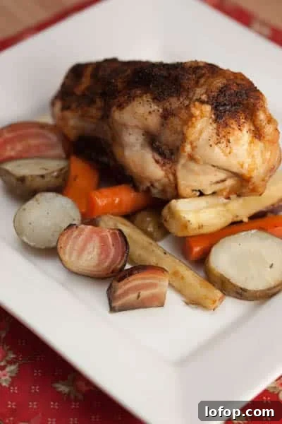 Roast chicken and root vegetables on a plate.