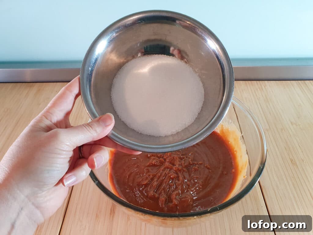 Decadent Egg-Free Brownies Recipe for Fudgy Chocolate Bliss 9 Adding white sugar to brownie mix.
