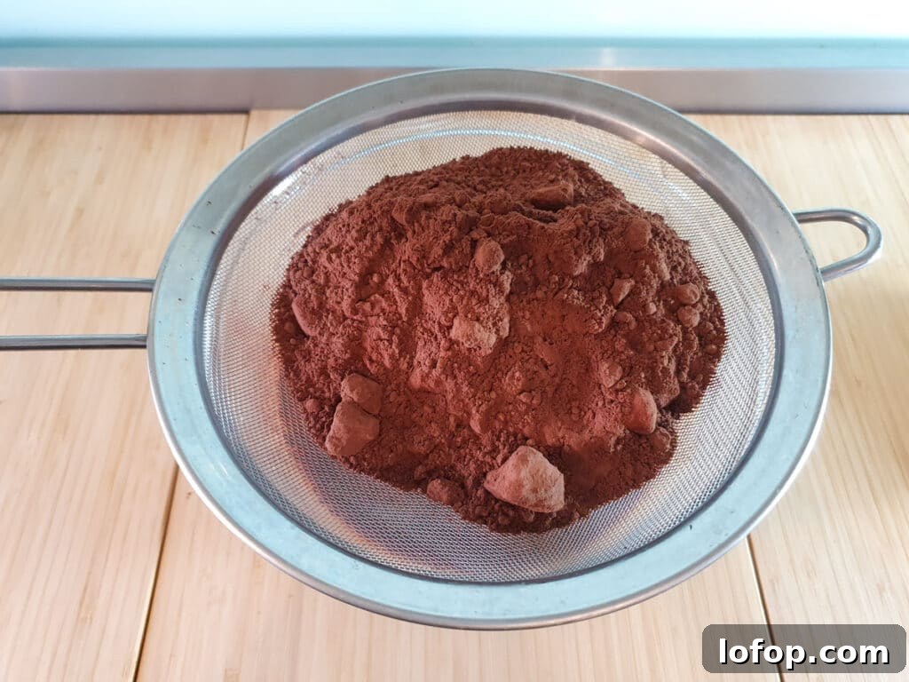 Decadent Egg-Free Brownies Recipe for Fudgy Chocolate Bliss 11 Sifting flour, cocoa powder, salt and baking powder into brownie mix.