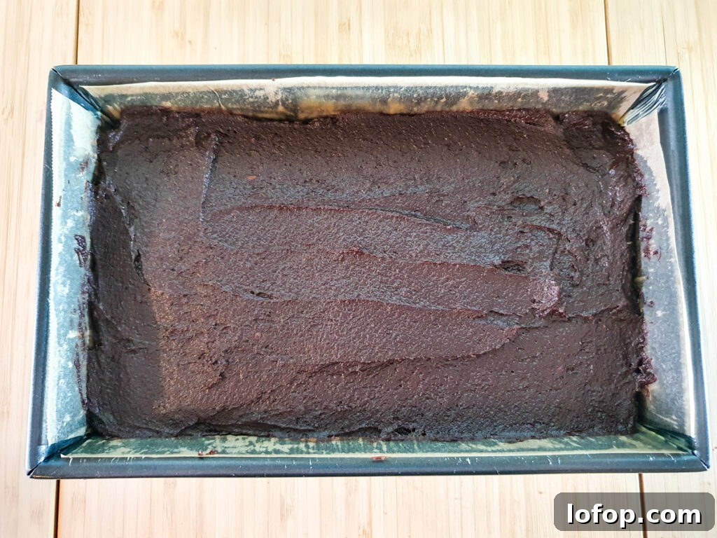Decadent Egg-Free Brownies Recipe for Fudgy Chocolate Bliss 12 Smoothing batter into lined brownie tin.