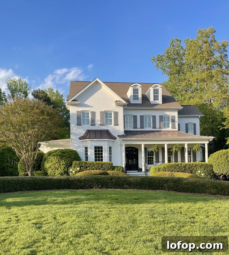 warm white brick house brown roof
