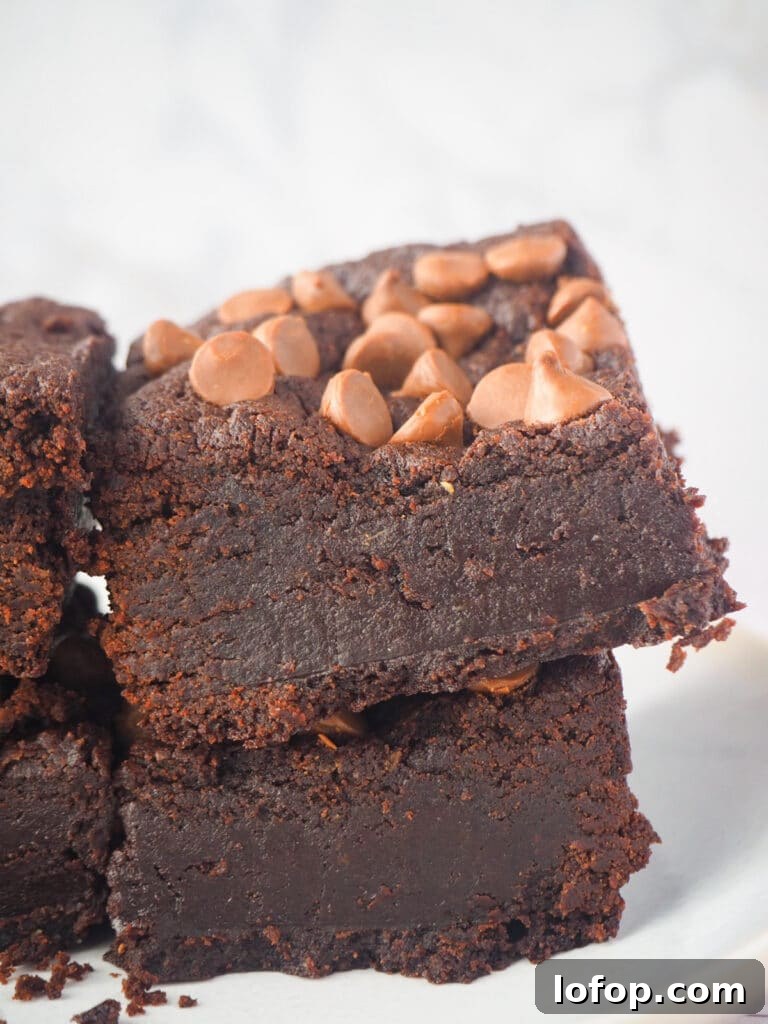 Decadent Egg-Free Brownies Recipe for Fudgy Chocolate Bliss 18 Close up side view of short stack of eggless brownies.