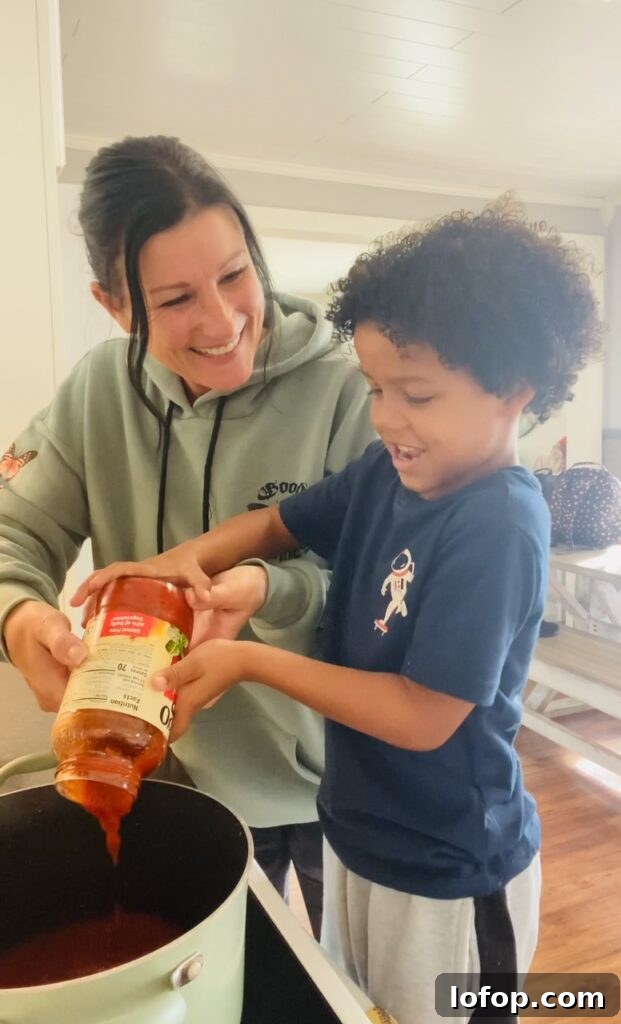 adding marinara sauce to Pasta with Tomato Cream Sauce