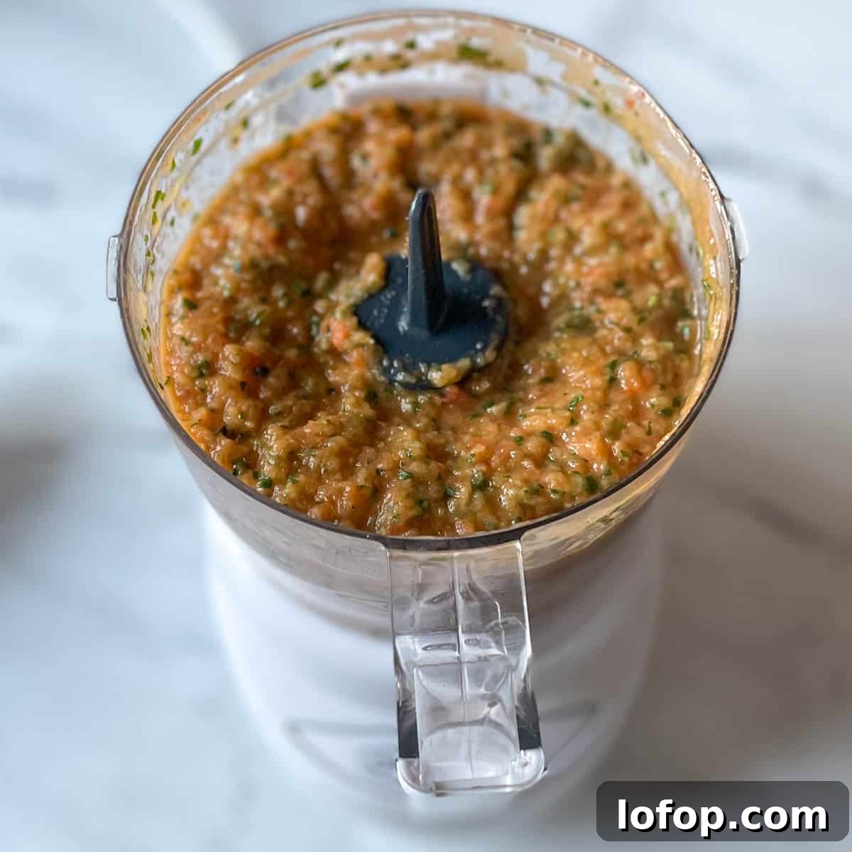 Tangy Pineapple Habanero Salsa Recipe for Grilling and Tacos 12 The finished, blended salsa is shown in a mini food processor.