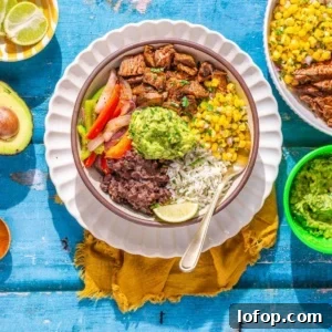 Steak and rice bowl on a flat surface.