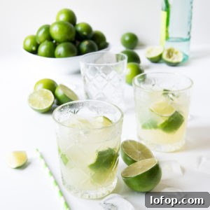 Authentic Caipirinha Recipe: Classic Brazilian Cocktail Guide 10 two caipirinhas on a white surface surrounded by ice and limes