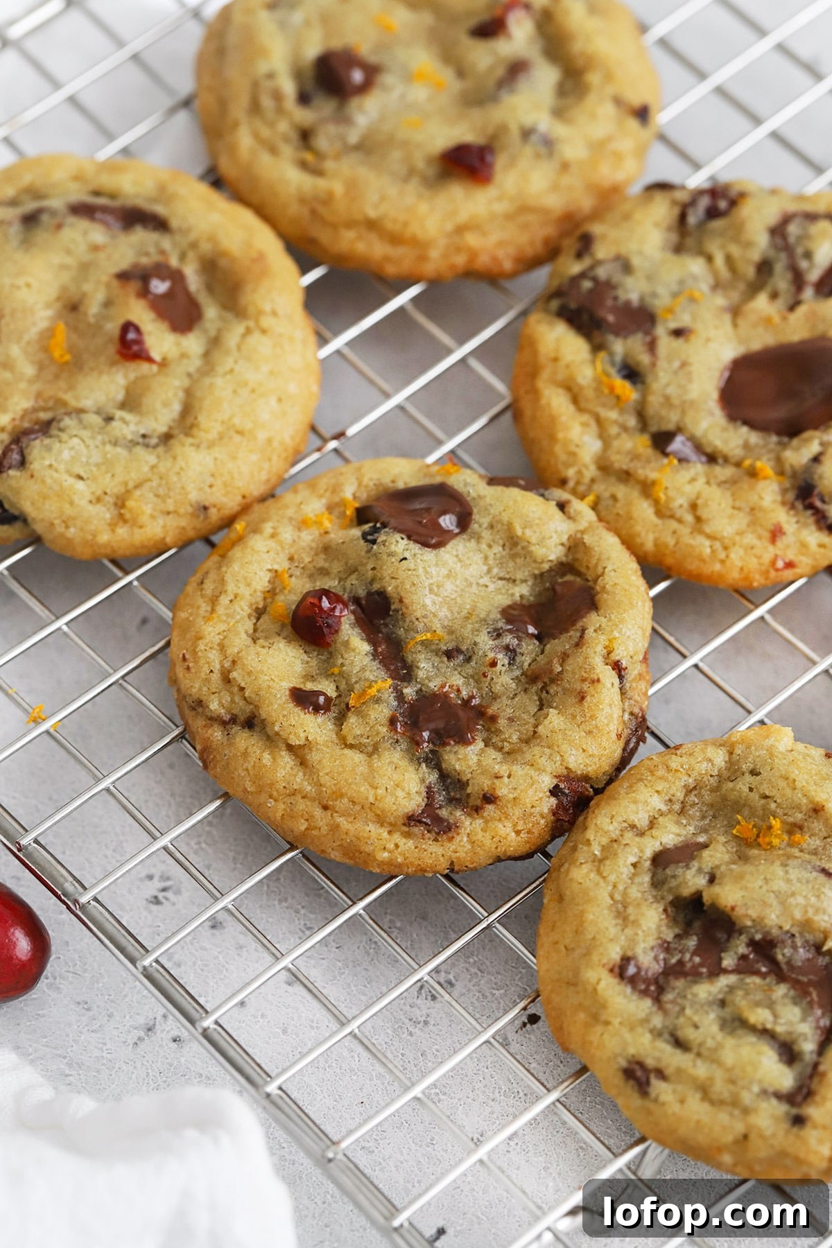 Gluten-Free Orange Cranberry Chocolate Chunk Cookies 10 Front view of gluten-free orange cranberry chocolate chip cookies cooling on a cooling rack