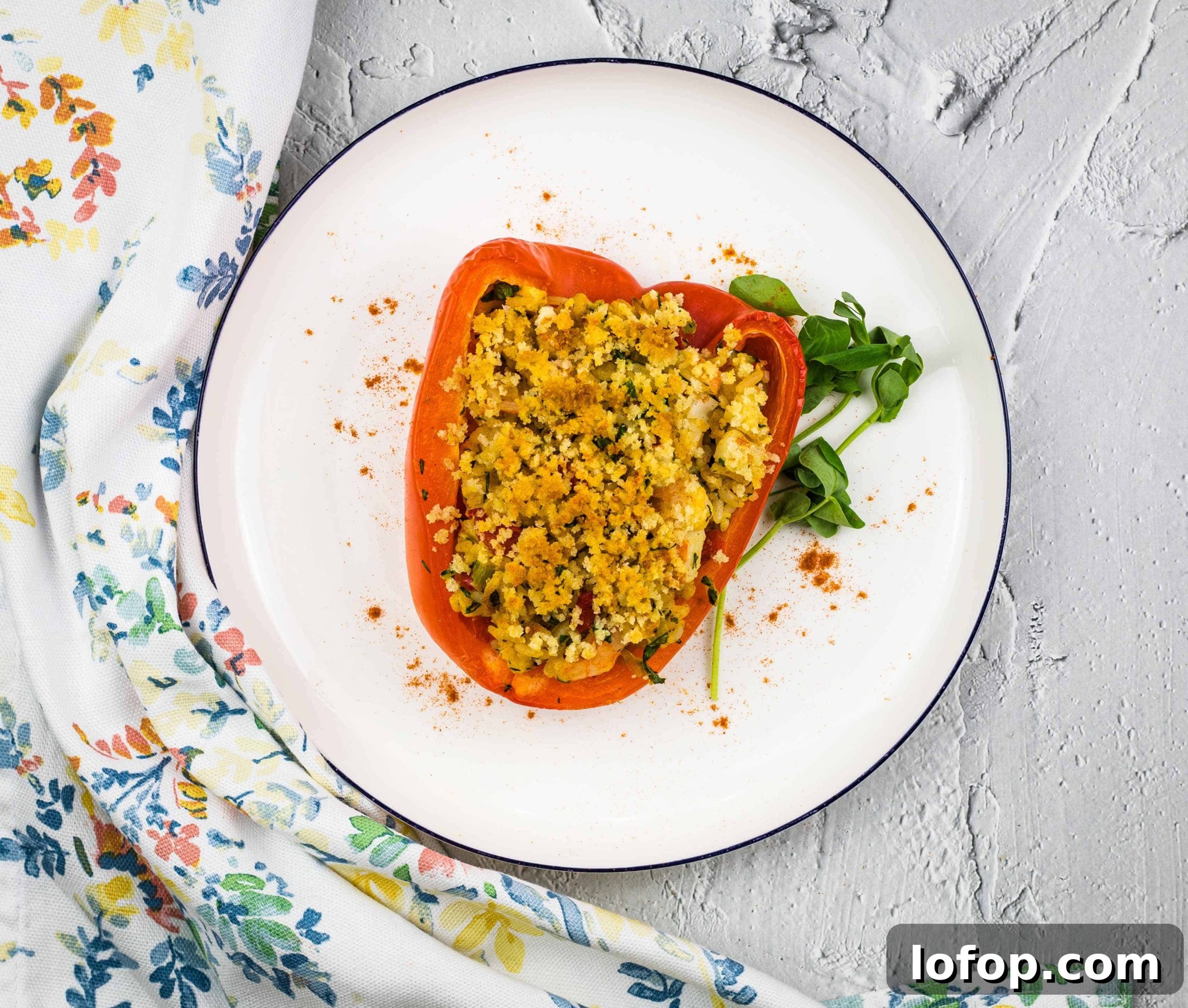 31 Irresistible Seafood Dinners to Add Fish to Your Weekly Menu 15 Stuffed red peppers on a white plate.