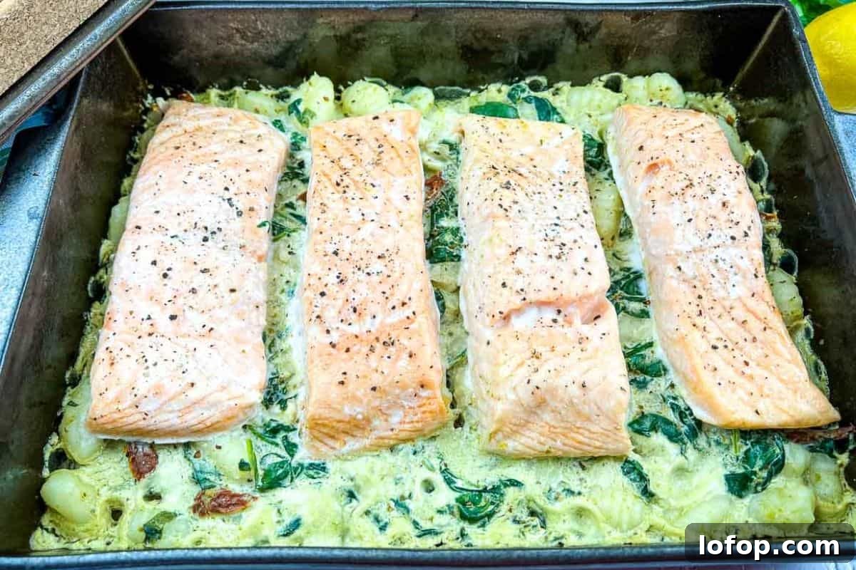 31 Irresistible Seafood Dinners to Add Fish to Your Weekly Menu 17 Salmon Gnocchi Bake on a casserole dish.
