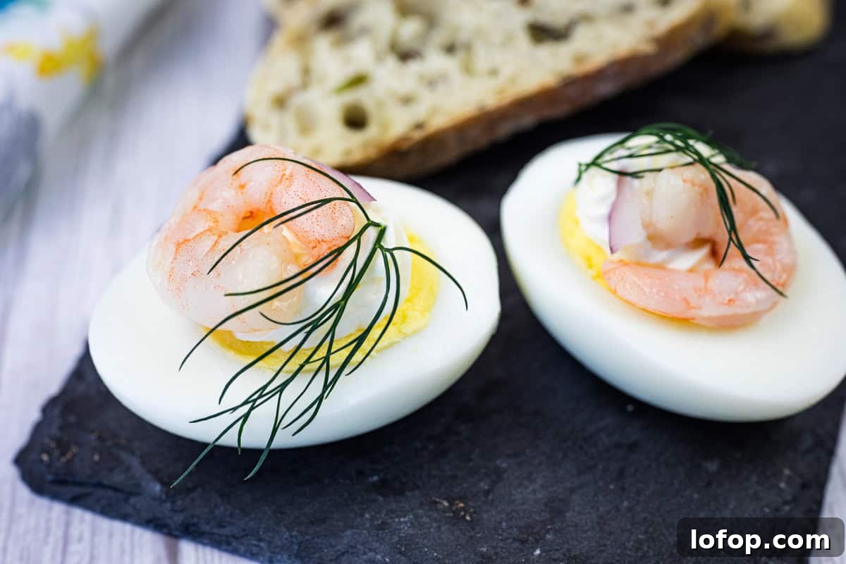 31 Irresistible Seafood Dinners to Add Fish to Your Weekly Menu 20 Two Pickled Shrimp Egg Shooter halves were placed on a slate board, next to slices of bread.