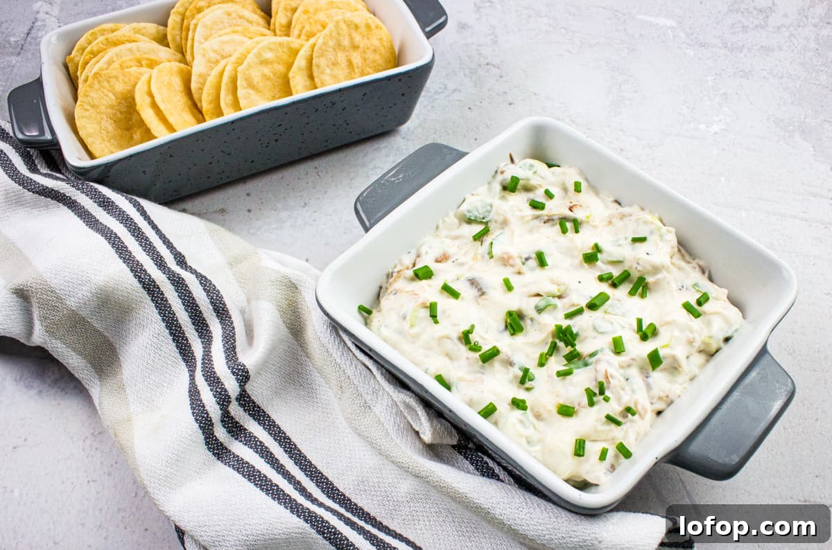 31 Irresistible Seafood Dinners to Add Fish to Your Weekly Menu 21 A bowl of cold crab dip with crackers and chives.