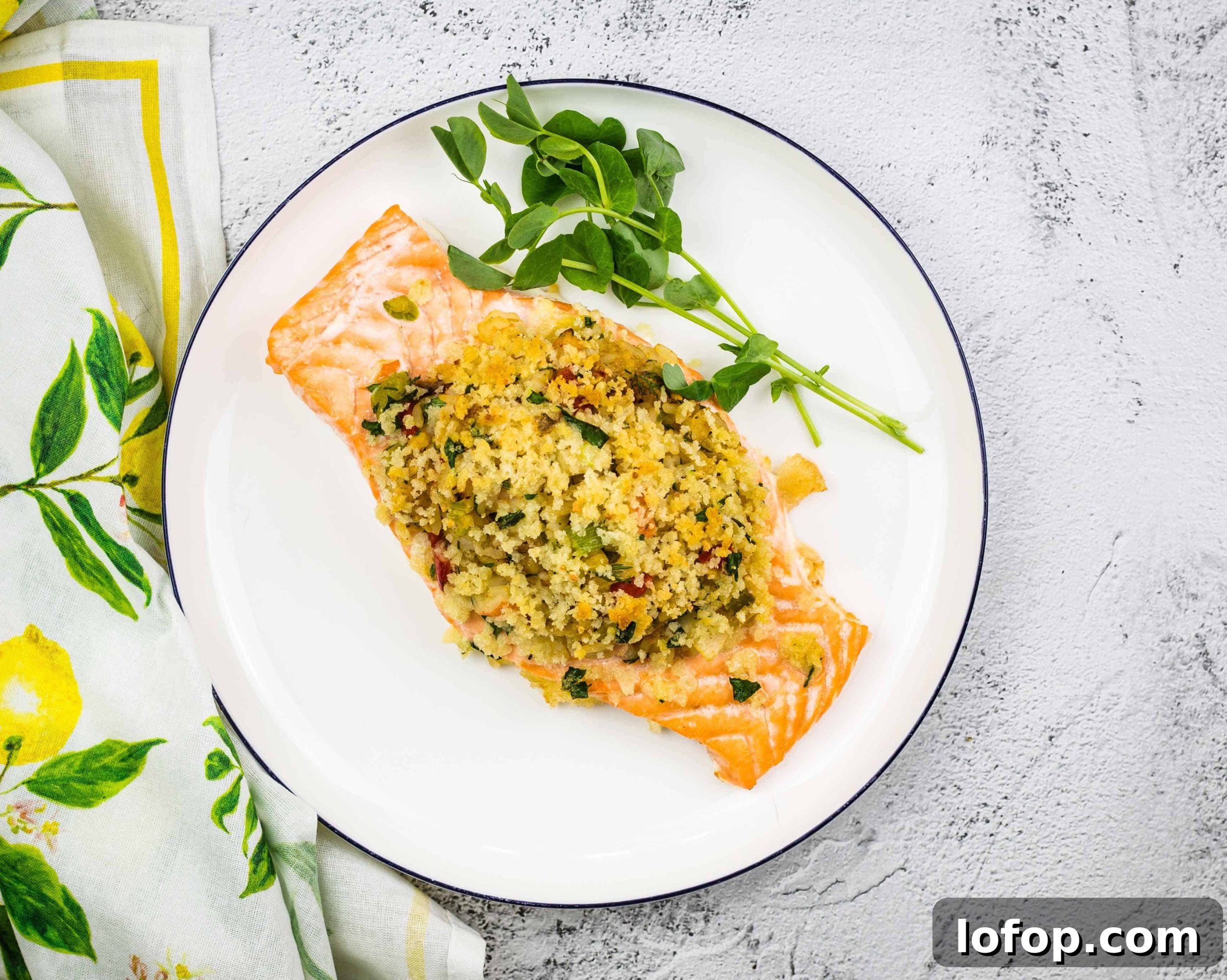 31 Irresistible Seafood Dinners to Add Fish to Your Weekly Menu 29 Seafood Stuffed Salmon on a circular white plate.