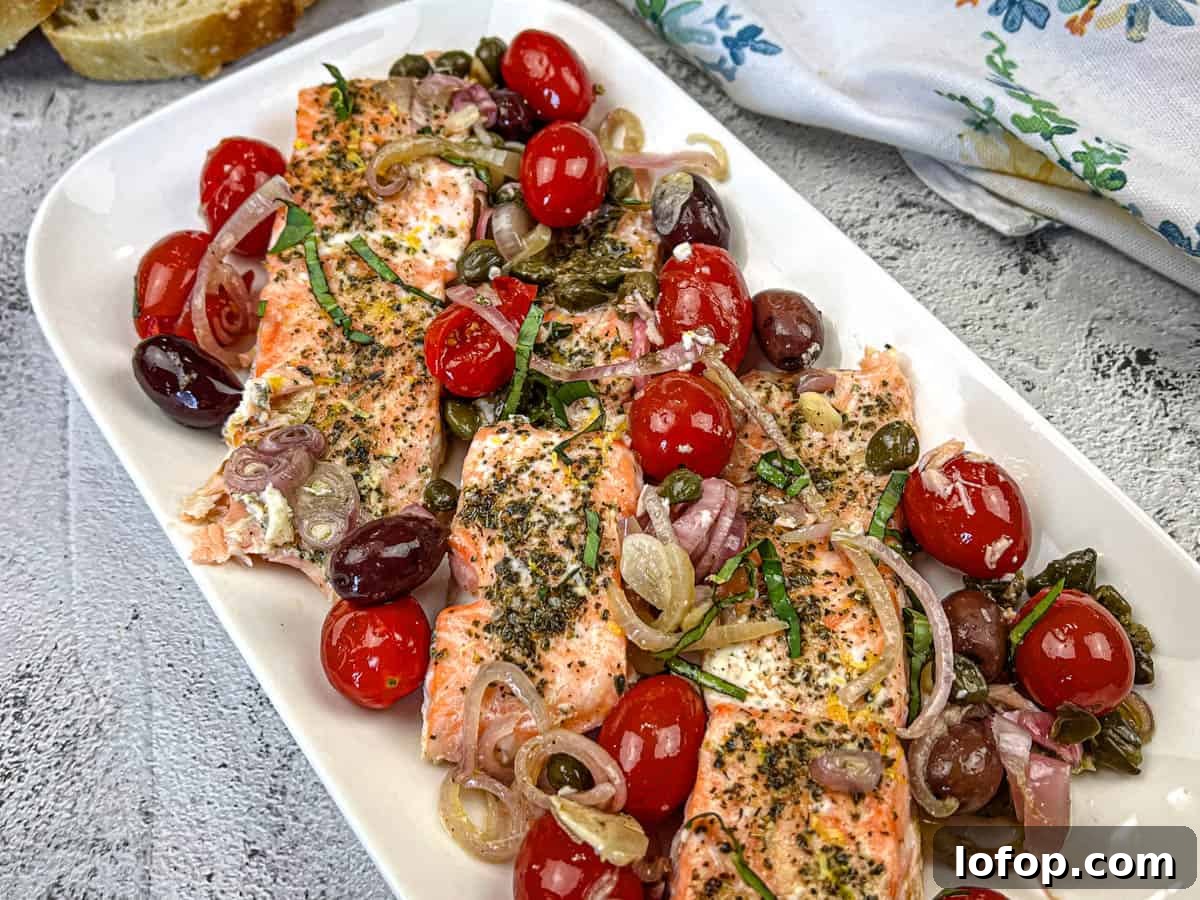 31 Irresistible Seafood Dinners to Add Fish to Your Weekly Menu 33 Mediterranean Salmon on a white rectangular plate.