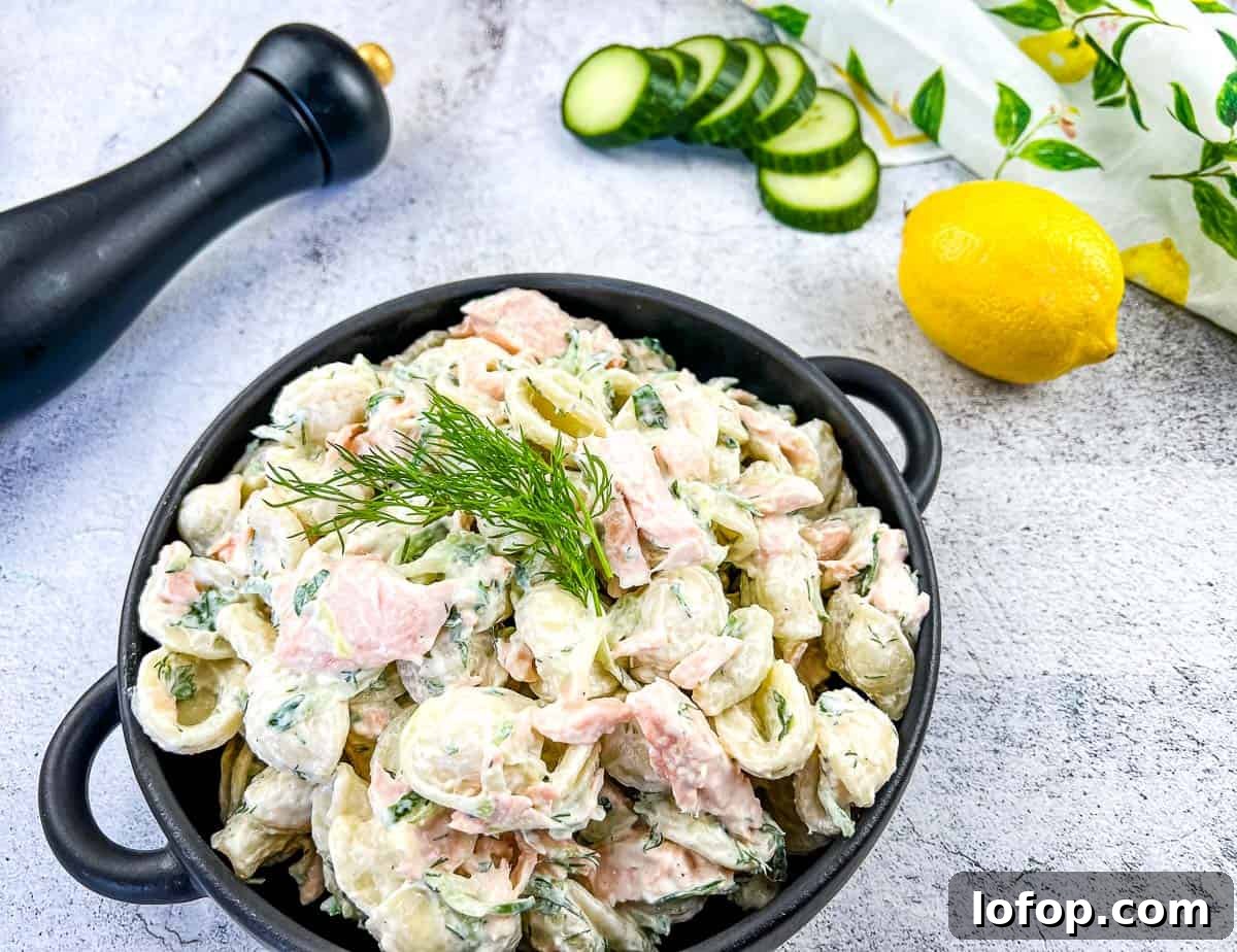 31 Irresistible Seafood Dinners to Add Fish to Your Weekly Menu 7 Salmon pasta salad in a black dish.