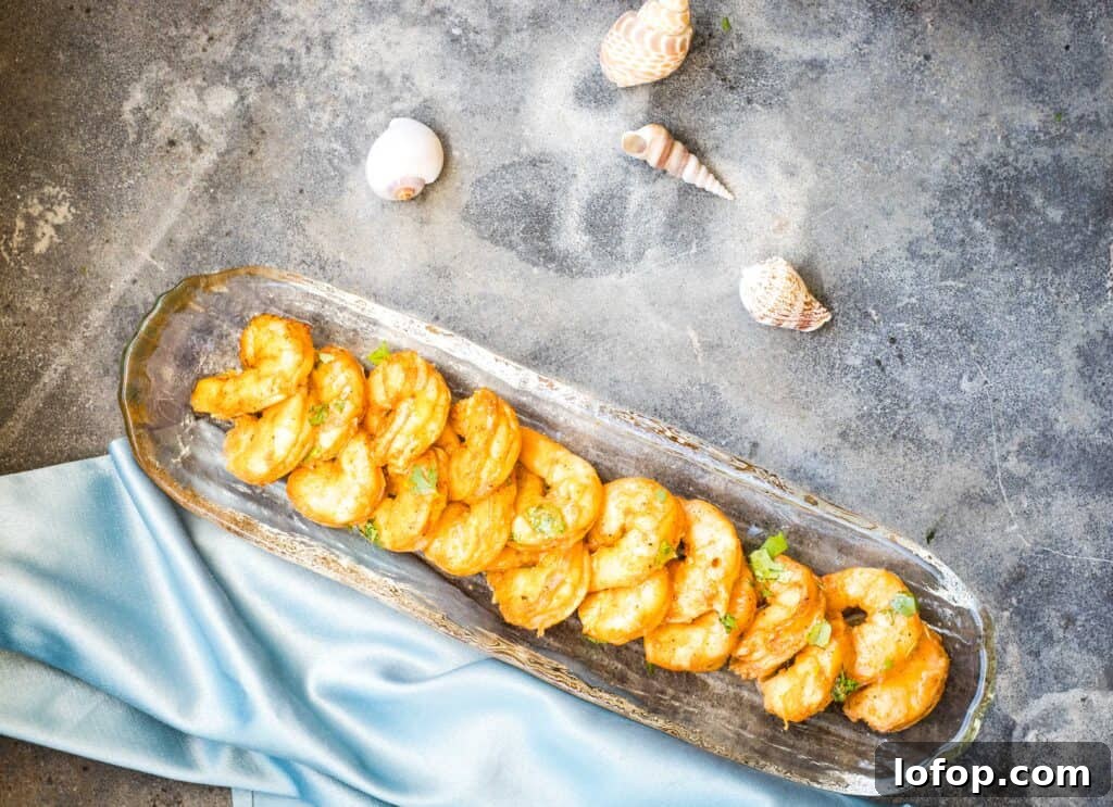 31 Irresistible Seafood Dinners to Add Fish to Your Weekly Menu 8 Two pans of smoked shrimp on a table.