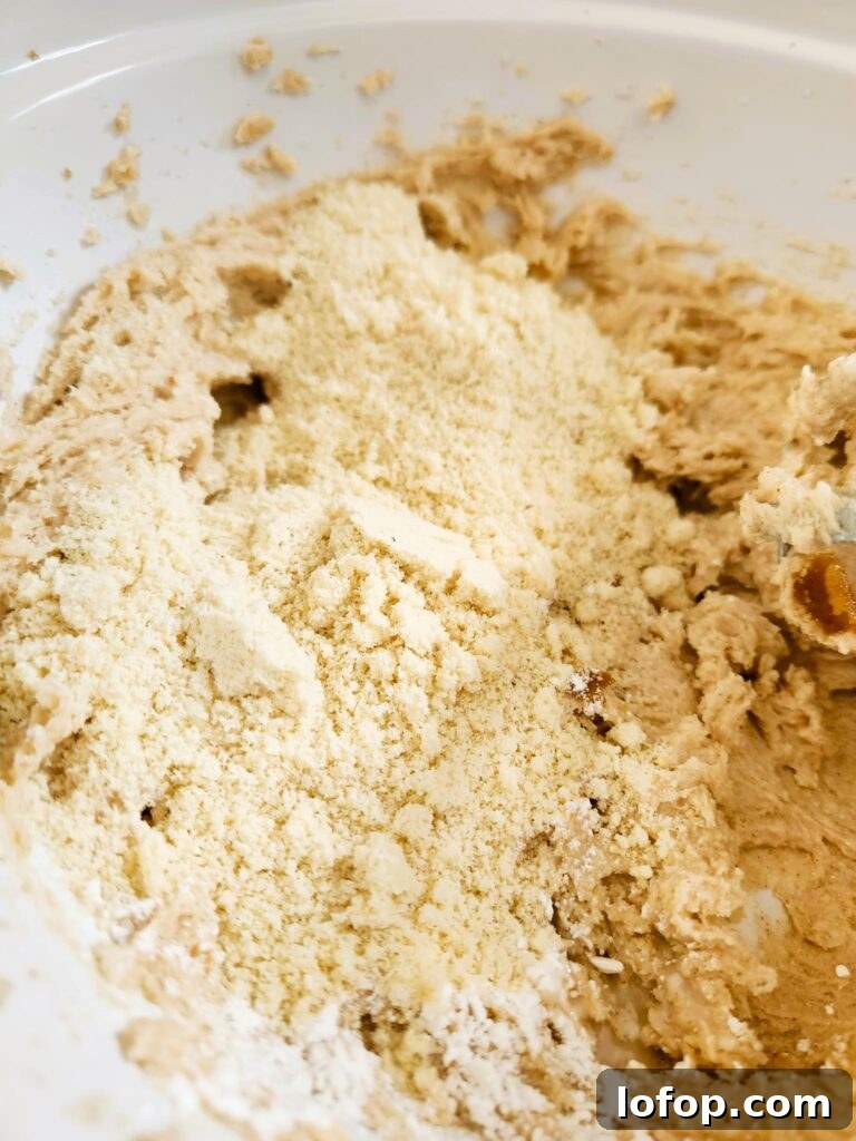 adding almond flour to cookie dough