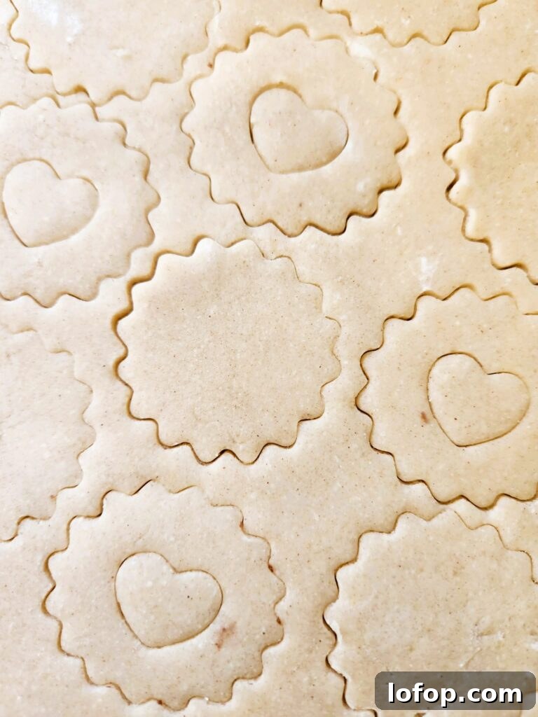Cutting shapes from chilled dough for Raspberry Linzer Cookies.
