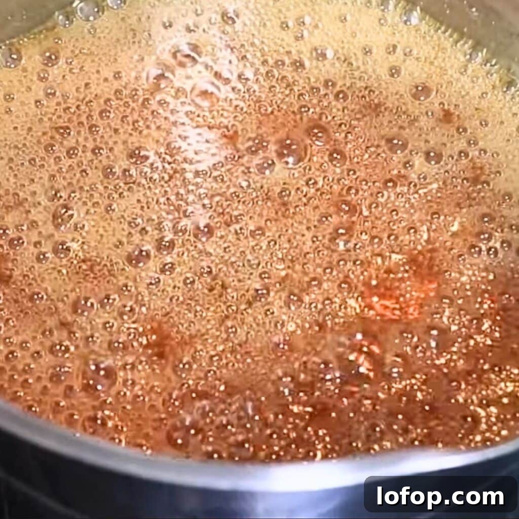 Heating sugar in a saucepan to make caramel