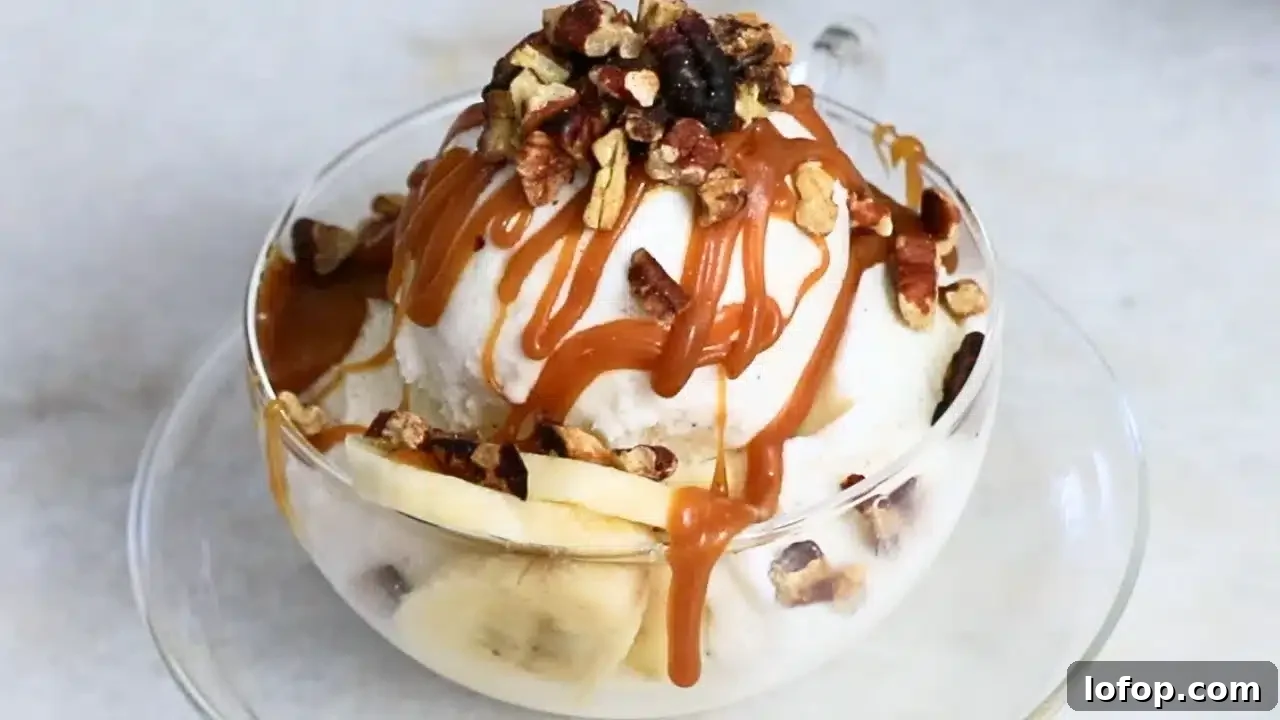 homemade caramel sauce and pecans on ice cream in a glass cup