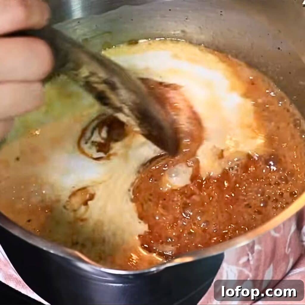 Adding hot heavy cream to caramel