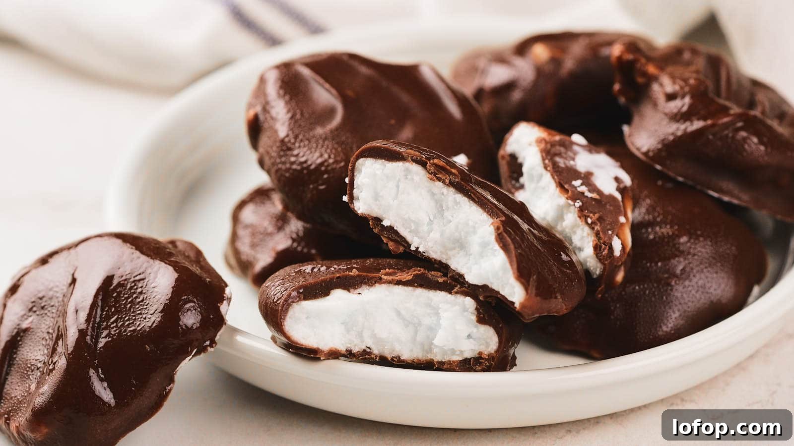 15 Decadent Low-Calorie Desserts That No One Will Suspect Are Light 16 A plate of pepeprmint patties, some whole and some split open to show the inside.