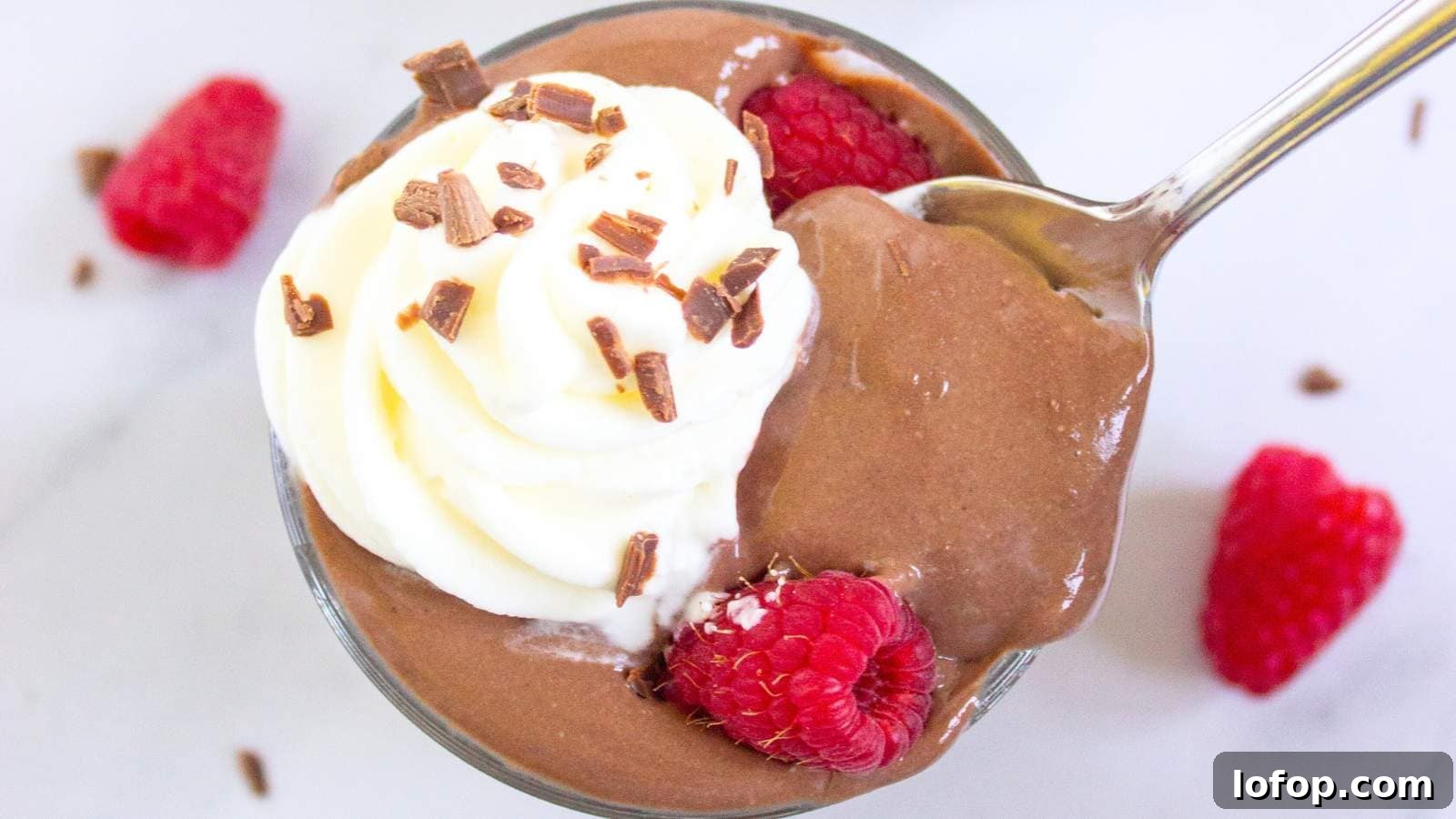 15 Decadent Low-Calorie Desserts That No One Will Suspect Are Light 5 A glass cup filled with protein pudding topped with whipped cream.
