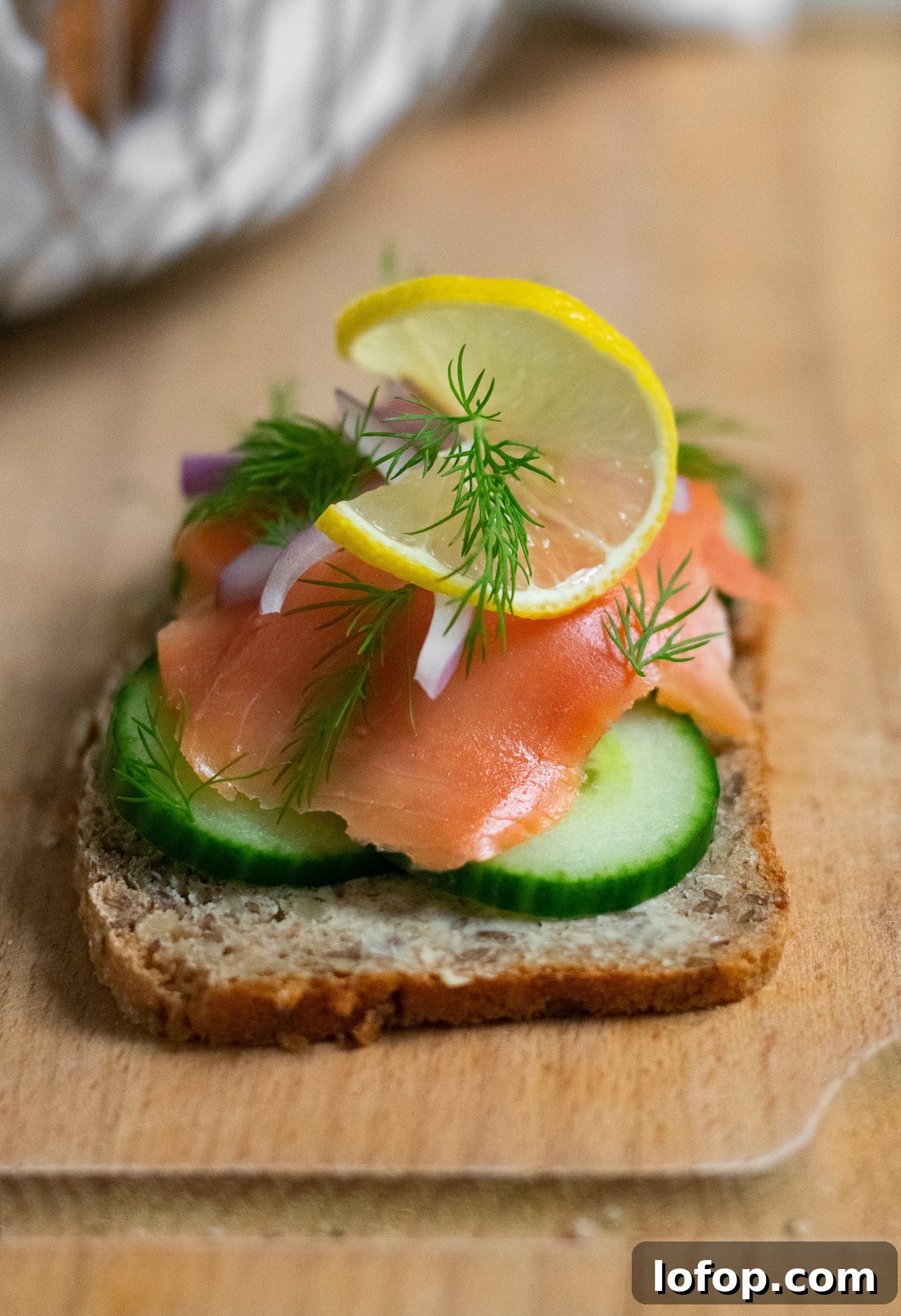 Smørrebrød: Traditional Danish Open-Faced Sandwich Recipes 15 A rye bread open faced sandwich topped with cucumber, smoked salmon, onion, lemon, and dill.