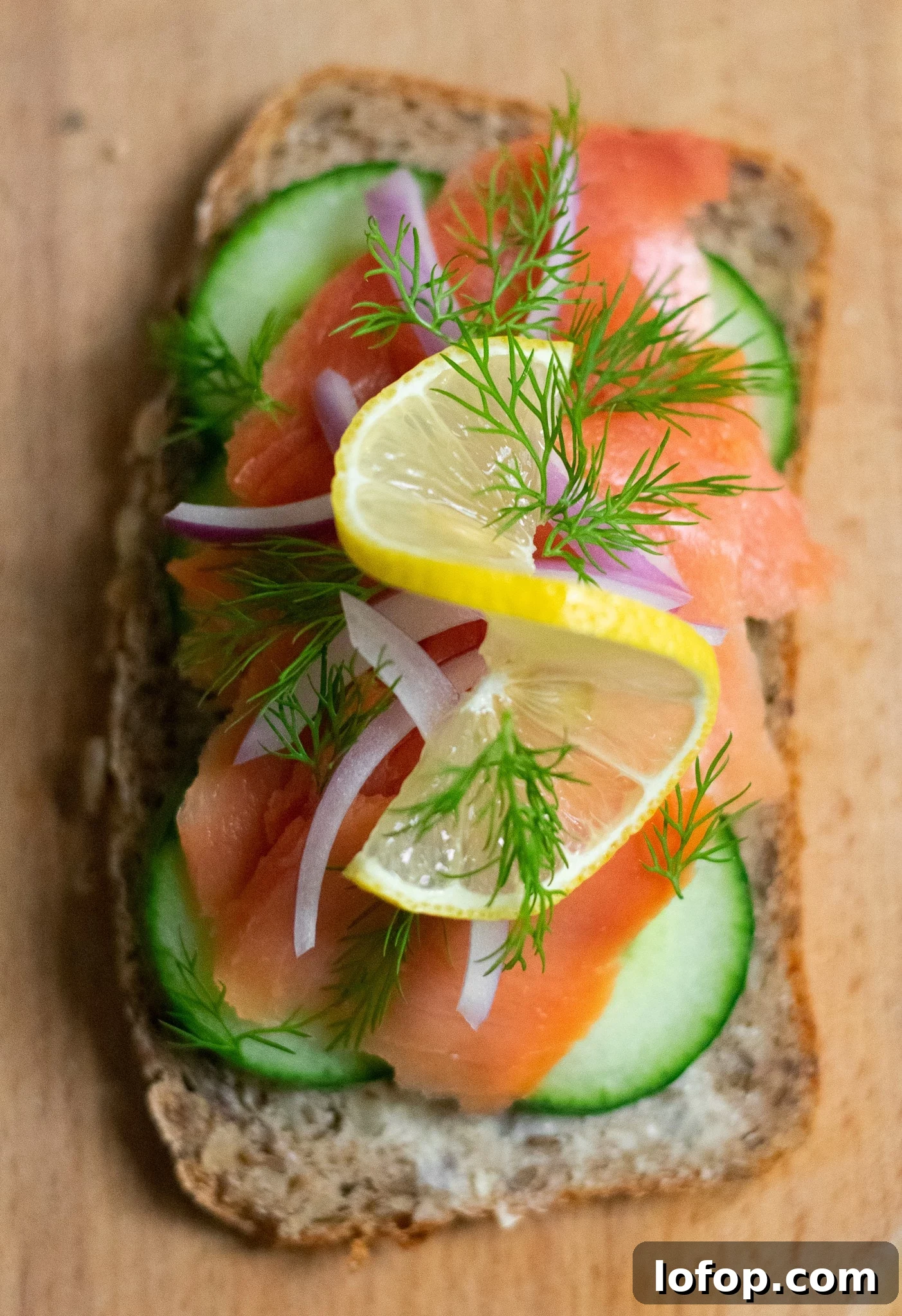 Smørrebrød: Traditional Danish Open-Faced Sandwich Recipes 16 A rye bread open faced sandwich topped with cucumber, smoked salmon, onion, lemon, and dill.