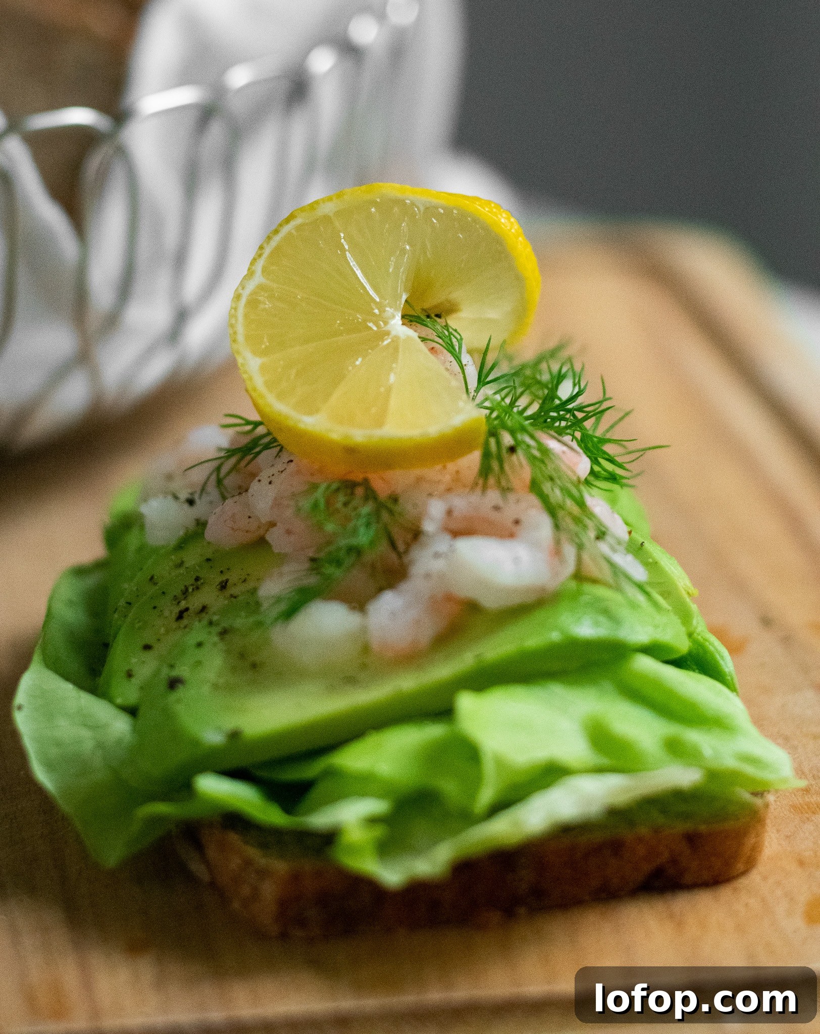 Smørrebrød: Traditional Danish Open-Faced Sandwich Recipes 17 A rye bread open faced sandwich topped with lettuce, avocado, baby shrimp, dill, and lemon.