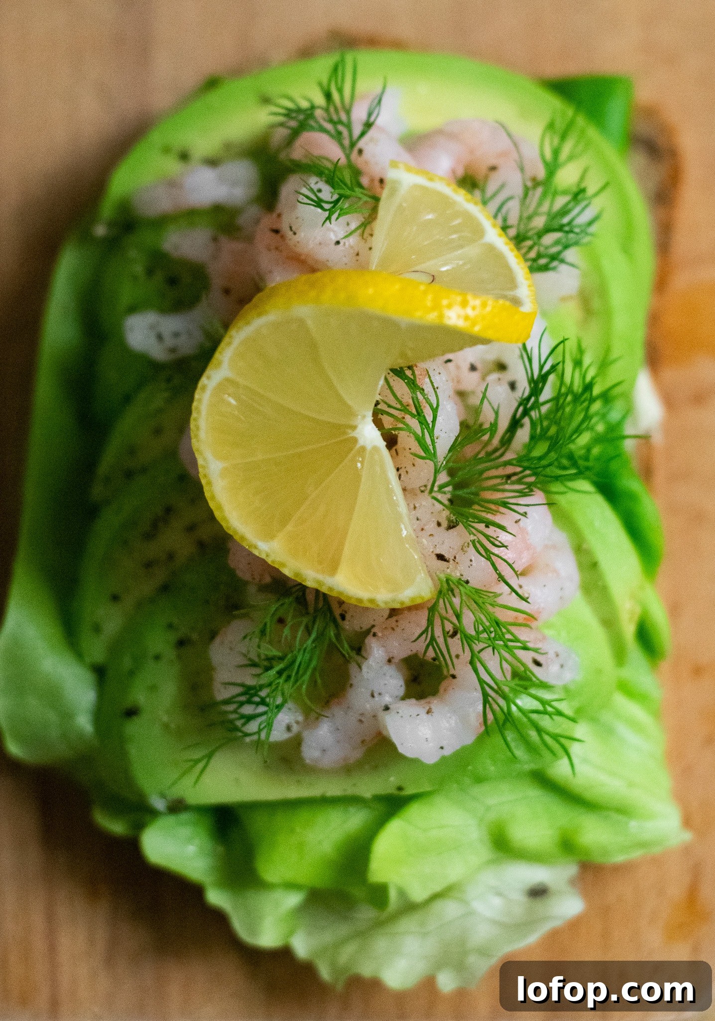 Smørrebrød: Traditional Danish Open-Faced Sandwich Recipes 18 A rye bread open faced sandwich topped with lettuce, avocado, baby shrimp, dill, and lemon.