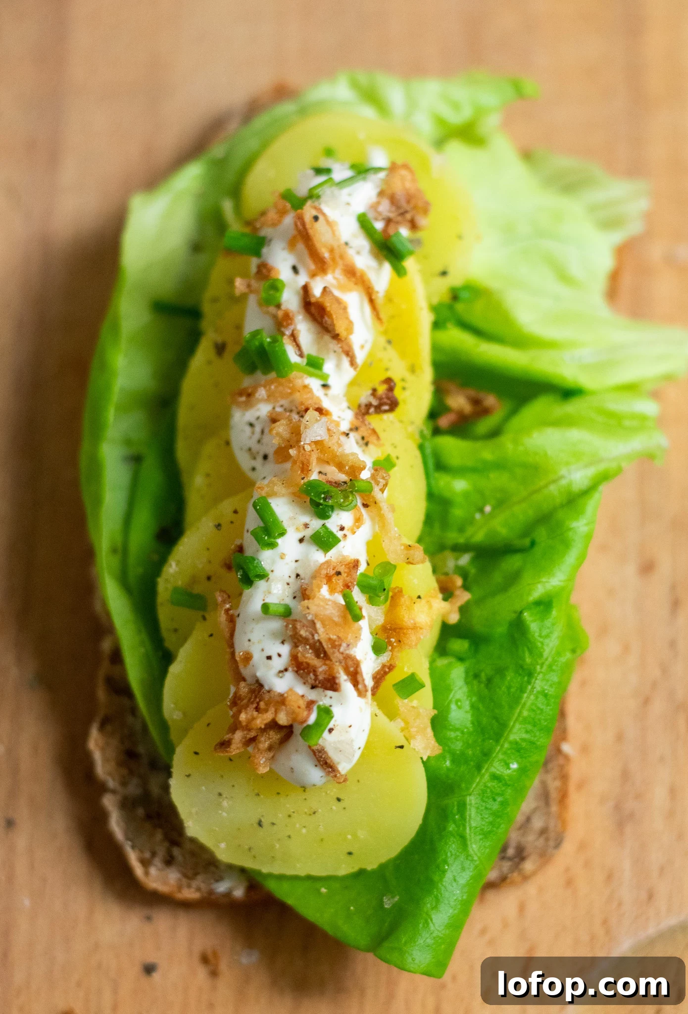 Smørrebrød: Traditional Danish Open-Faced Sandwich Recipes 28 A rye bread open faced sandwich topped with lettuce, potato, sour cream, chives, and fried onion.