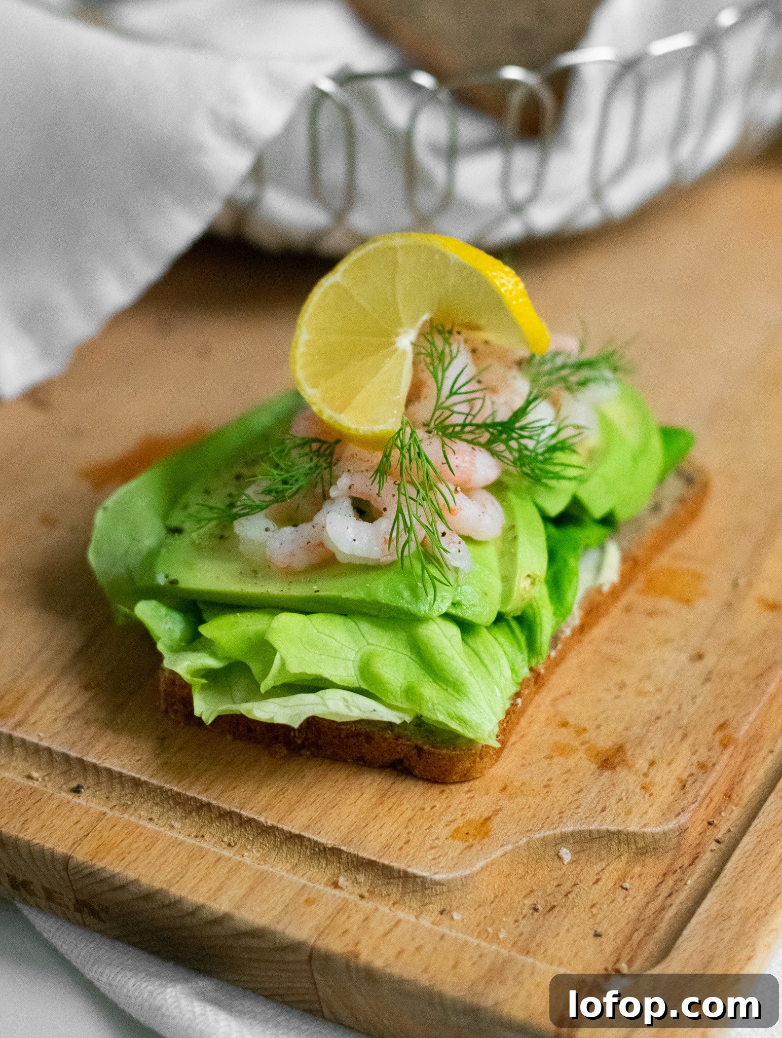 Smørrebrød: Traditional Danish Open-Faced Sandwich Recipes 29 A rye bread open faced sandwich topped with lettuce, avocado, baby shrimp, dill, and lemon.