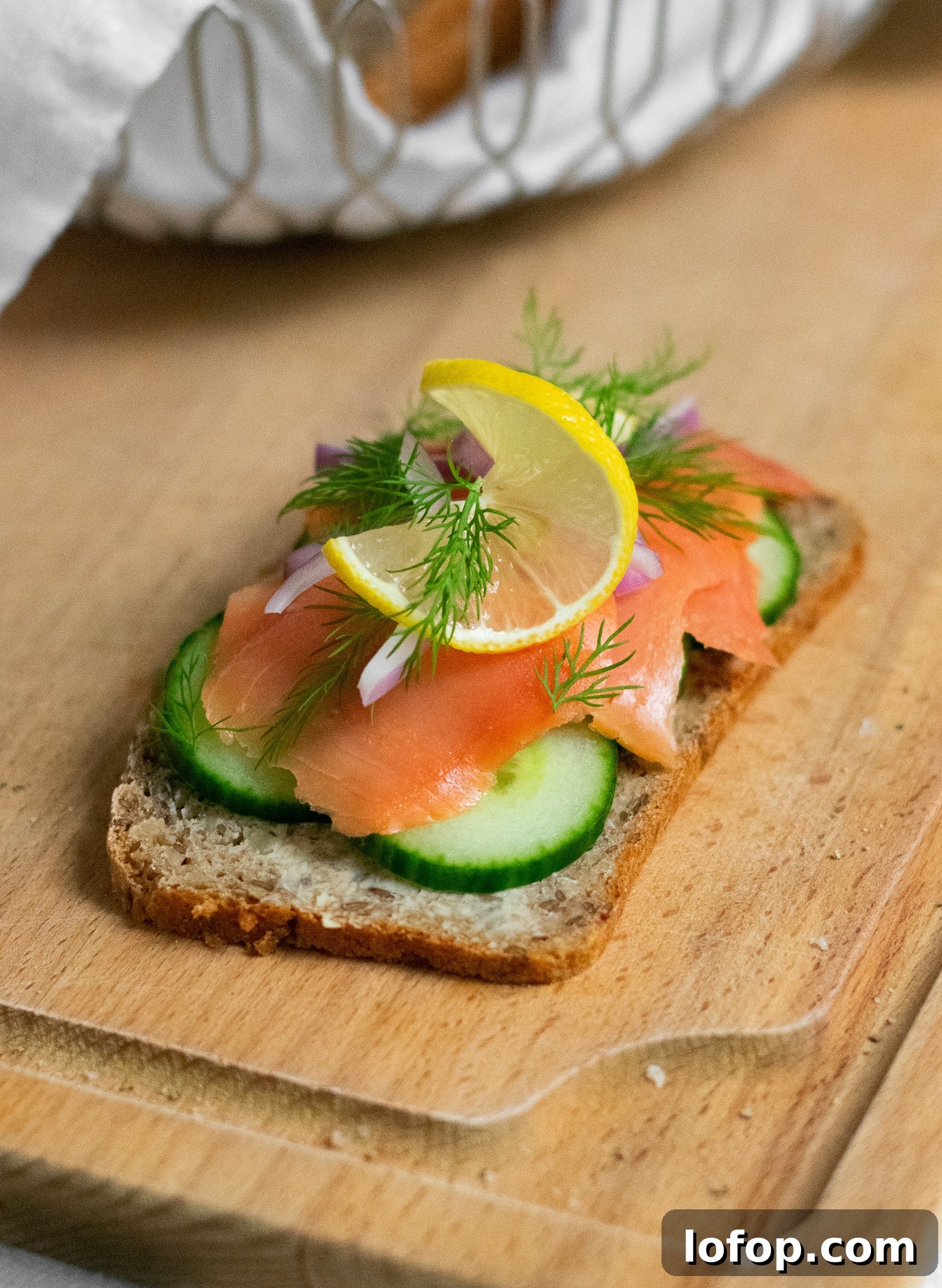 Smørrebrød: Traditional Danish Open-Faced Sandwich Recipes 32 A rye bread open faced sandwich topped with cucumber, smoked salmon, onion, lemon, and dill.